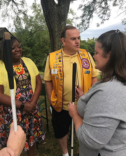 Melissa Smith chats with local Lions Club president Doreen Jackson and another Lions Club member.